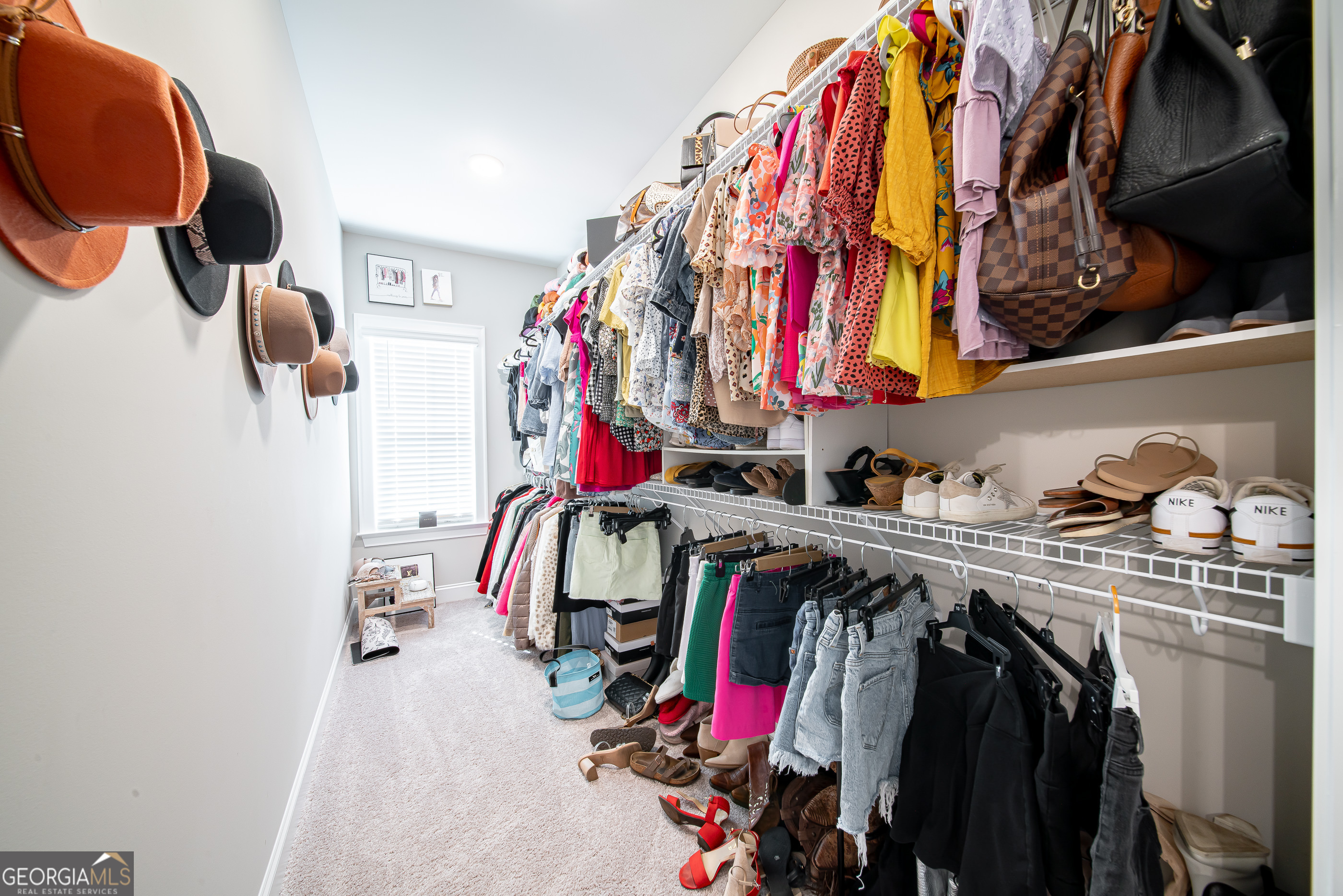 96 Cypress Trail Fortson, GA 31808 - Photo 46 of 62 a view of walk in closet with clothes and shoes