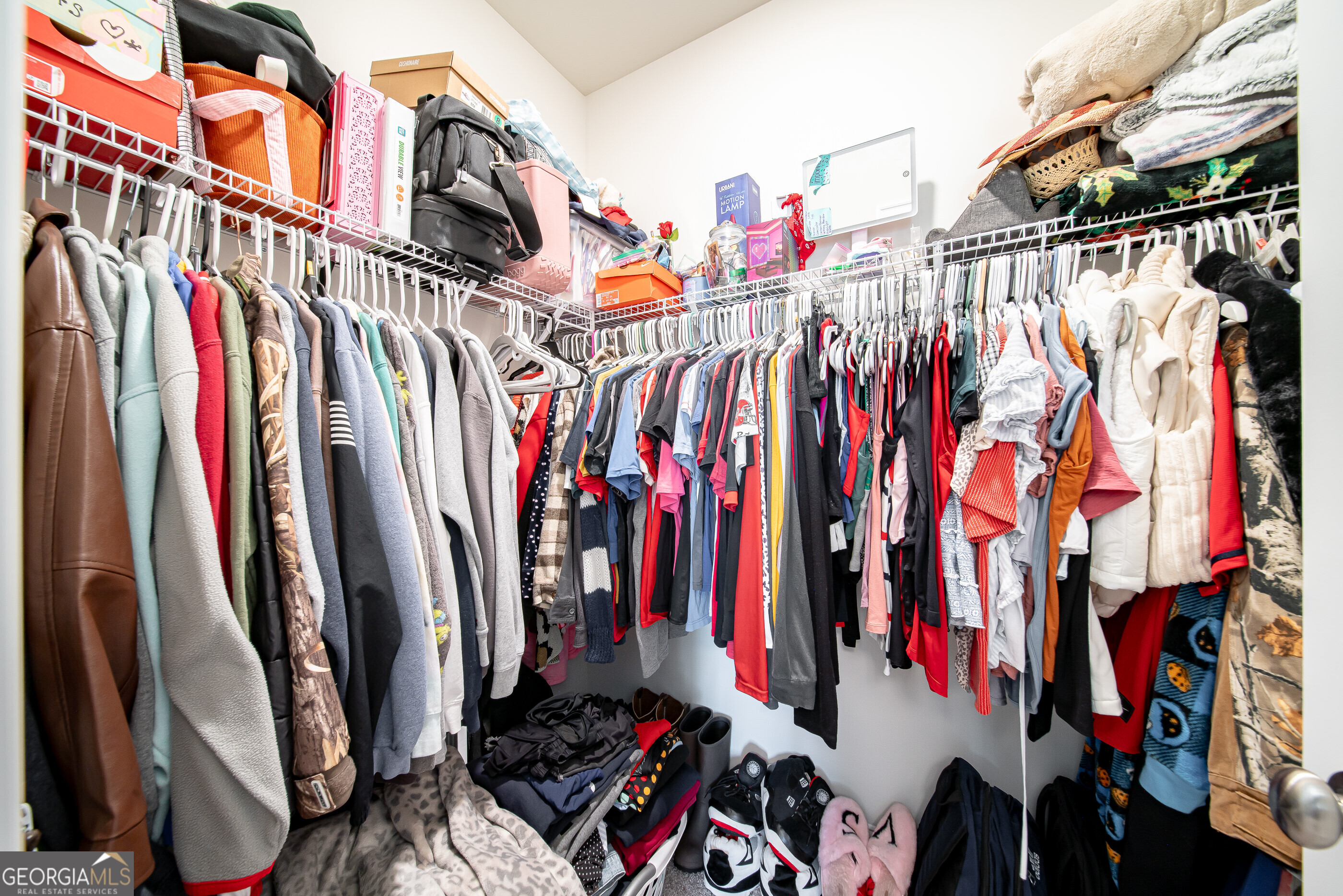 96 Cypress Trail Fortson, GA 31808 - Photo 54 of 62 a view of walk in closet with clothes