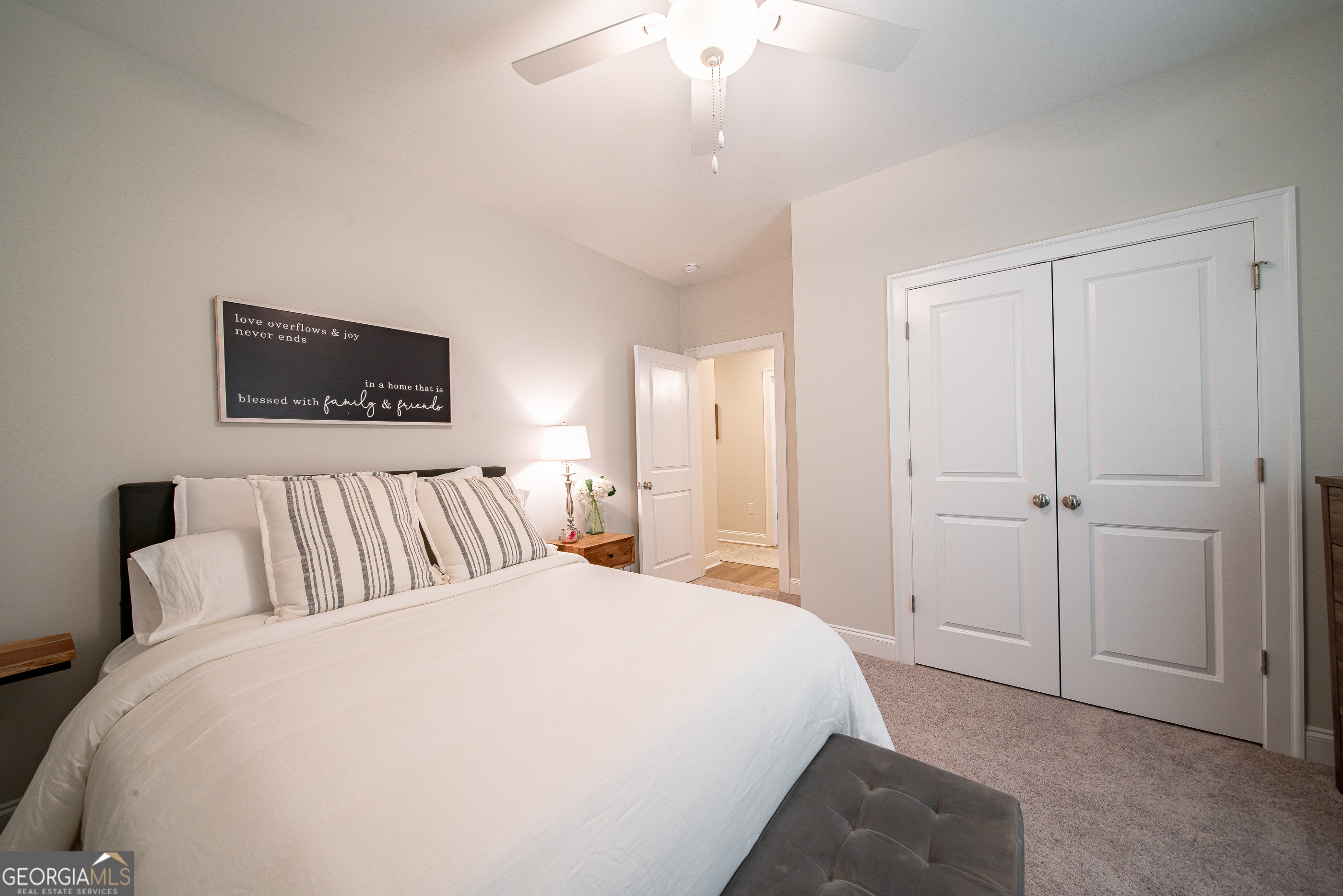 96 Cypress Trail Fortson, GA 31808 - Photo 57 of 62 a spacious bedroom with a large bed and a chandelier