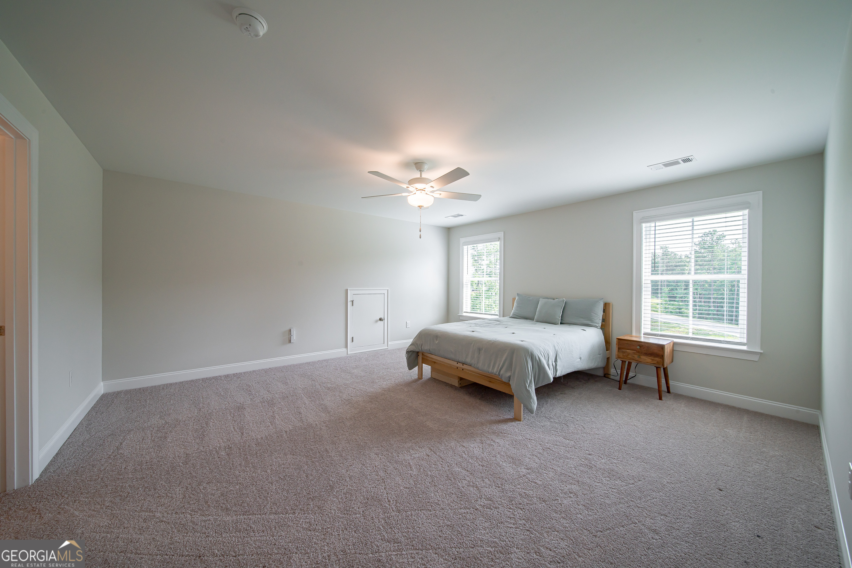 96 Cypress Trail Fortson, GA 31808 - Photo 59 of 62 a spacious bedroom with a bed and a window