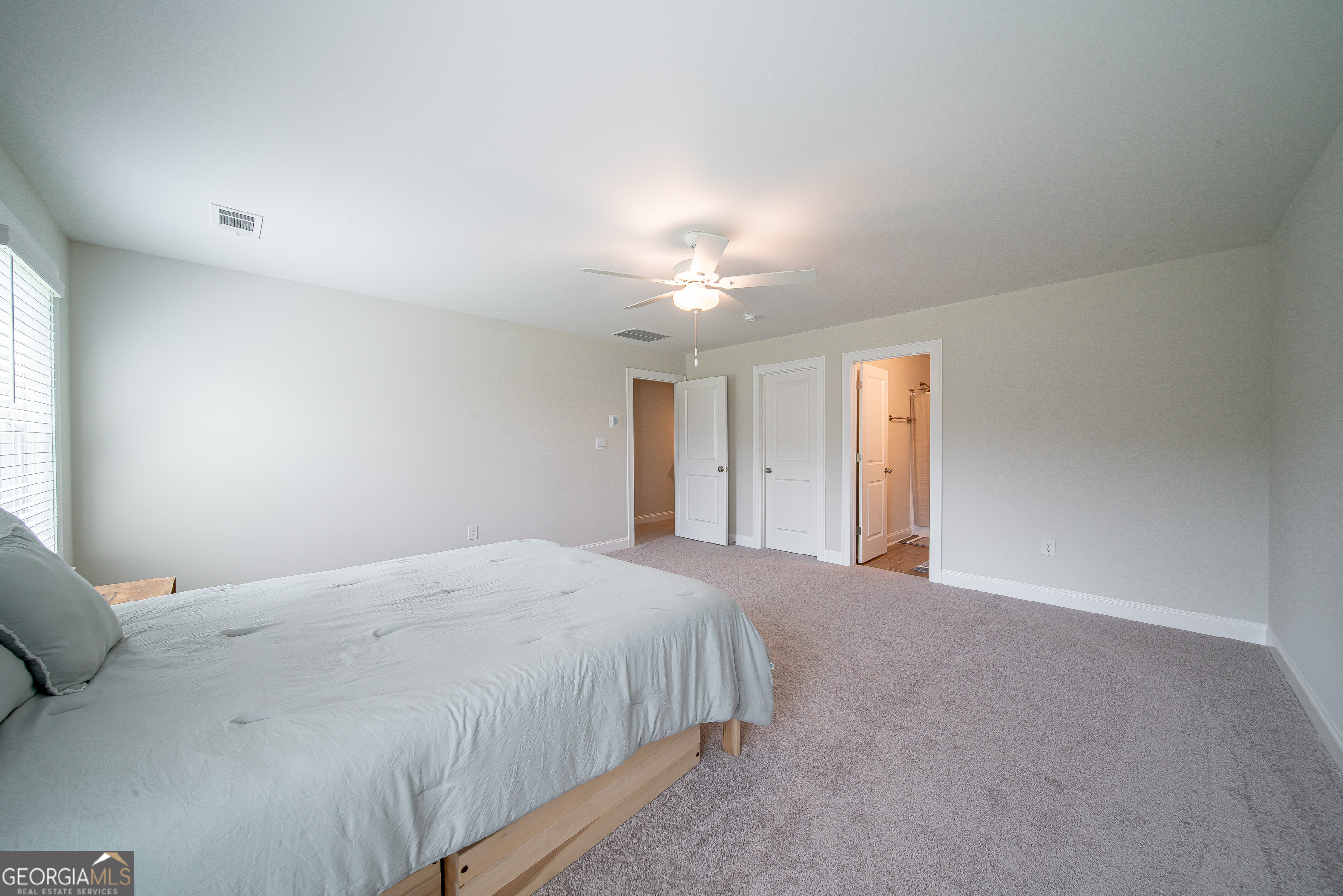 96 Cypress Trail Fortson, GA 31808 - Photo 60 of 62 a bedroom with a bed and a chandelier