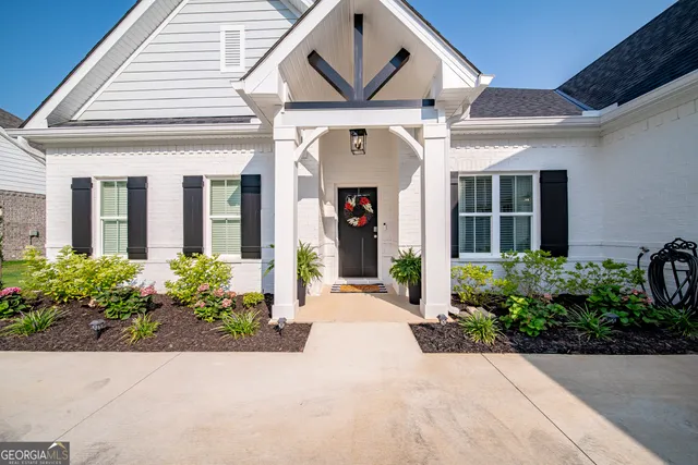 a house view with swimming pool in front of it