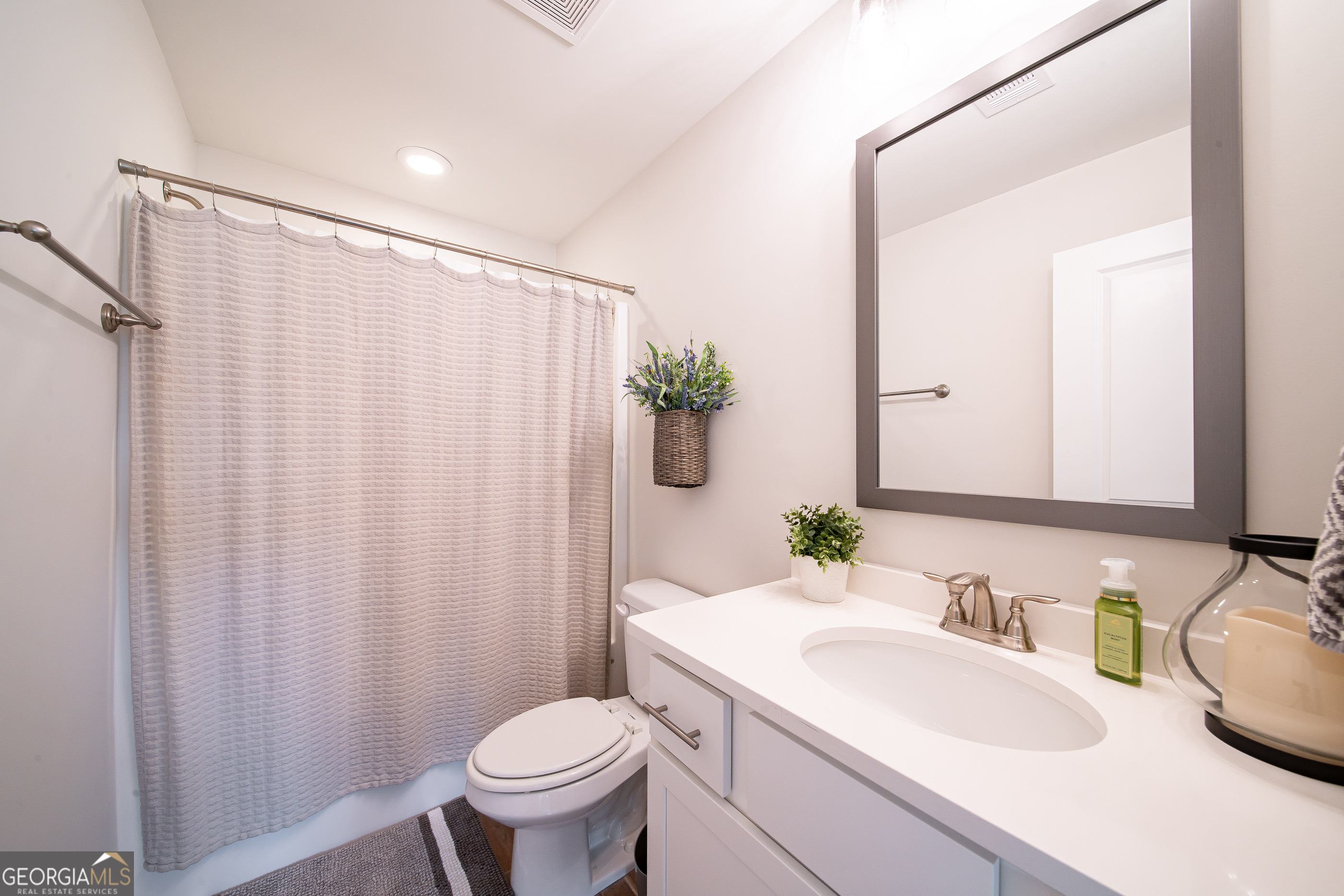 96 Cypress Trail Fortson, GA 31808 - Photo 61 of 62 a bathroom with a sink a toilet and shower curtain