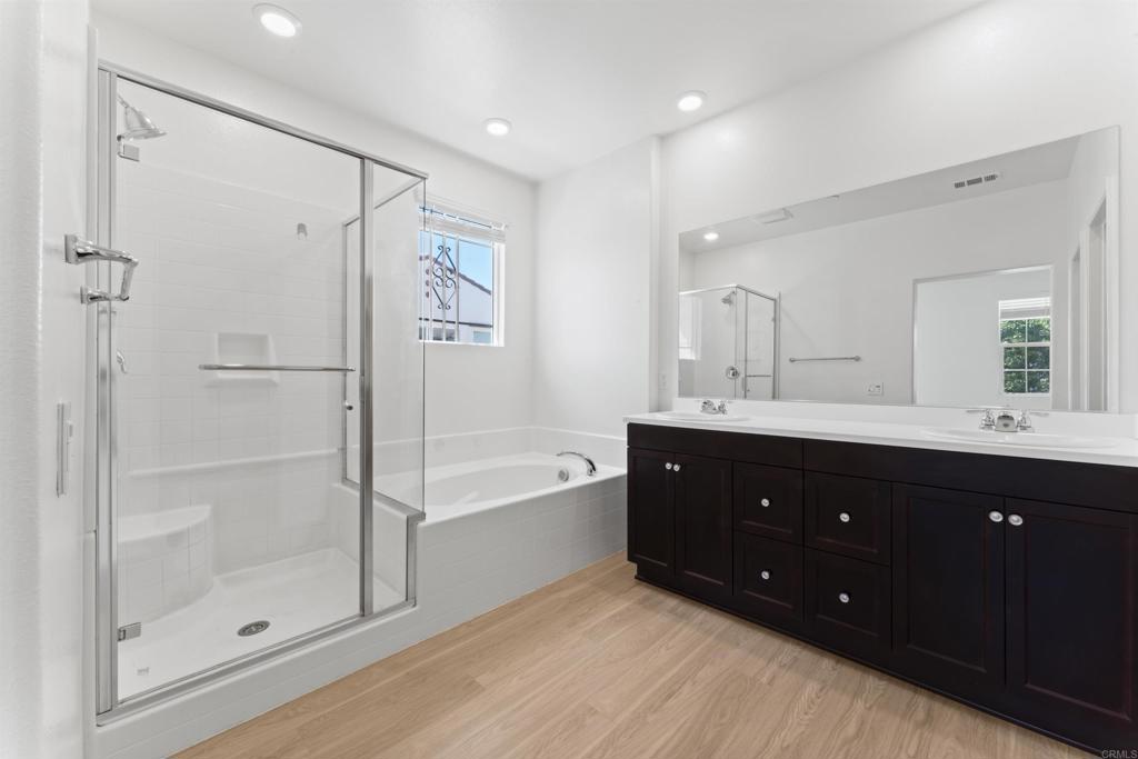 30320 Town Square Drive Menifee, CA 92584 - Photo 14 of 28 a bathroom with a tub sink shower and mirror