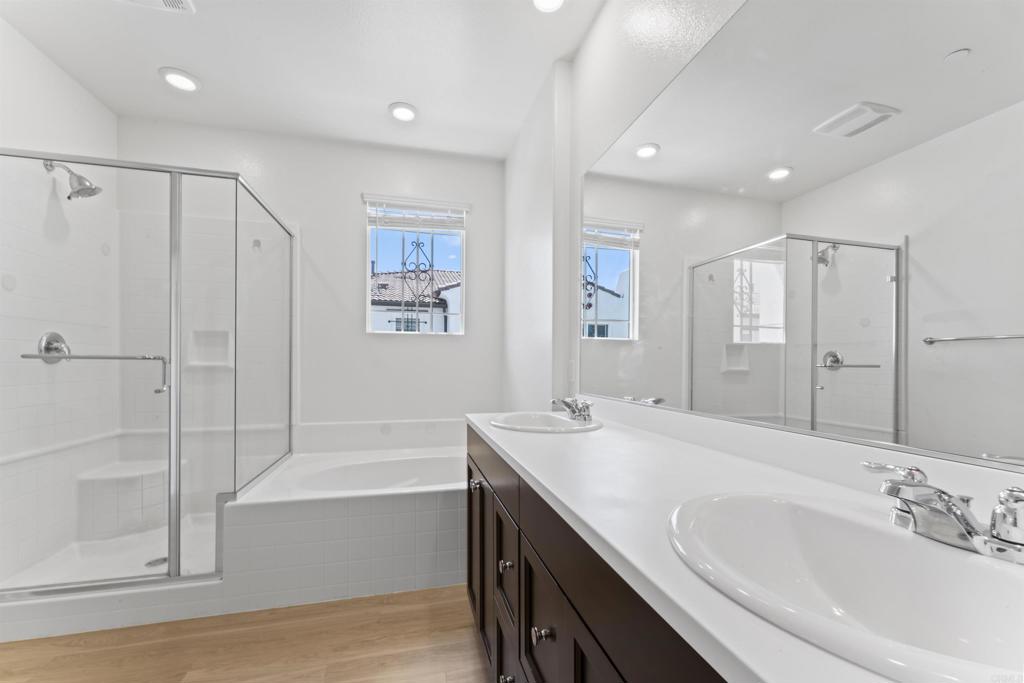 30320 Town Square Drive Menifee, CA 92584 - Photo 15 of 28 a bathroom with a tub sink and mirror