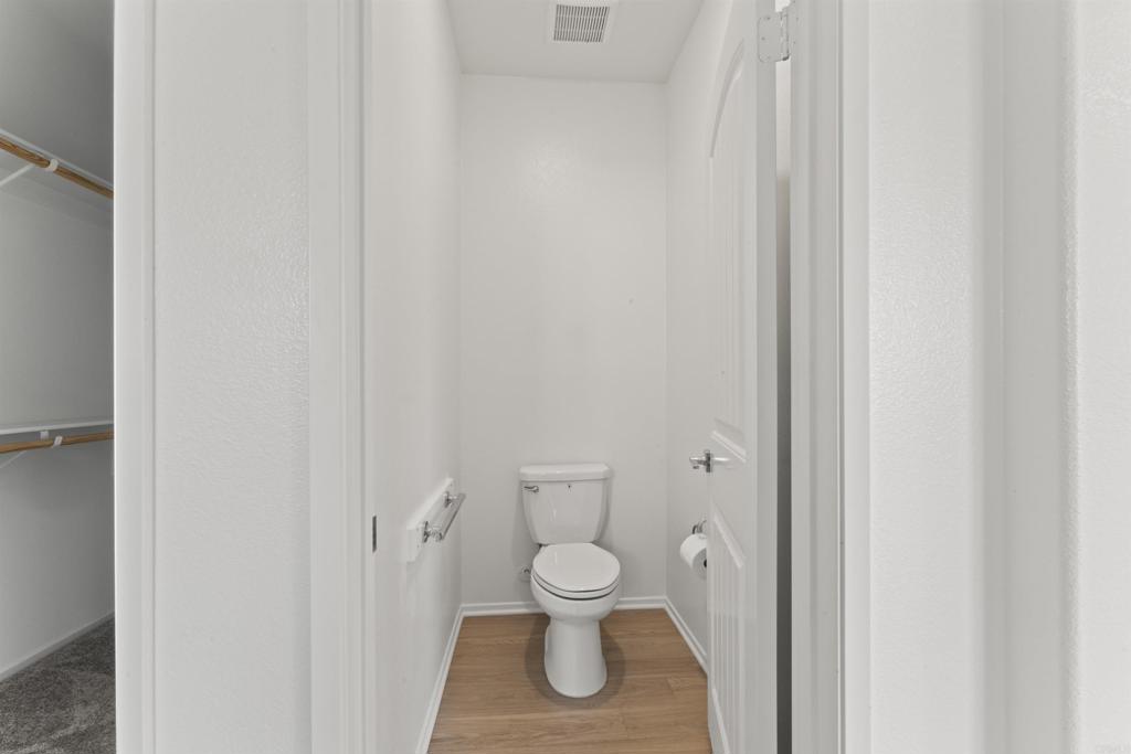 30320 Town Square Drive Menifee, CA 92584 - Photo 16 of 28 a bathroom with a toilet and a shower