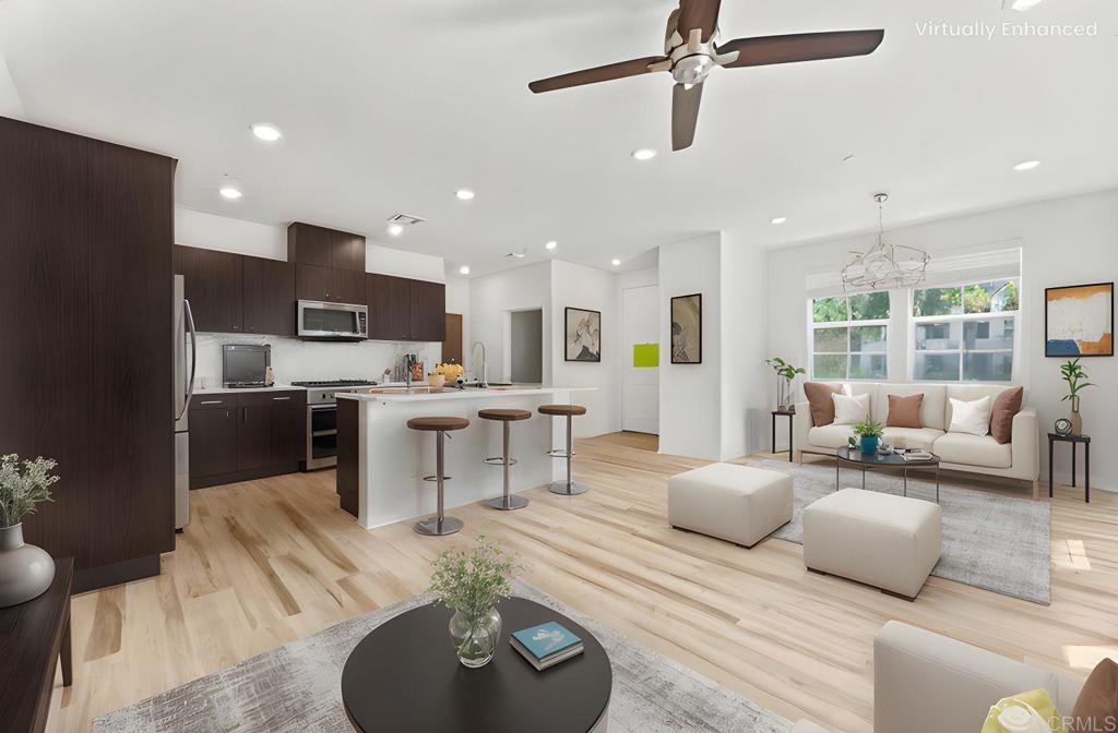 30320 Town Square Drive Menifee, CA 92584 - Photo 2 of 28 a living room with furniture kitchen view and a chandelier