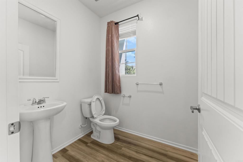 30320 Town Square Drive Menifee, CA 92584 - Photo 6 of 28 a white toilet sitting next to a bathroom sink