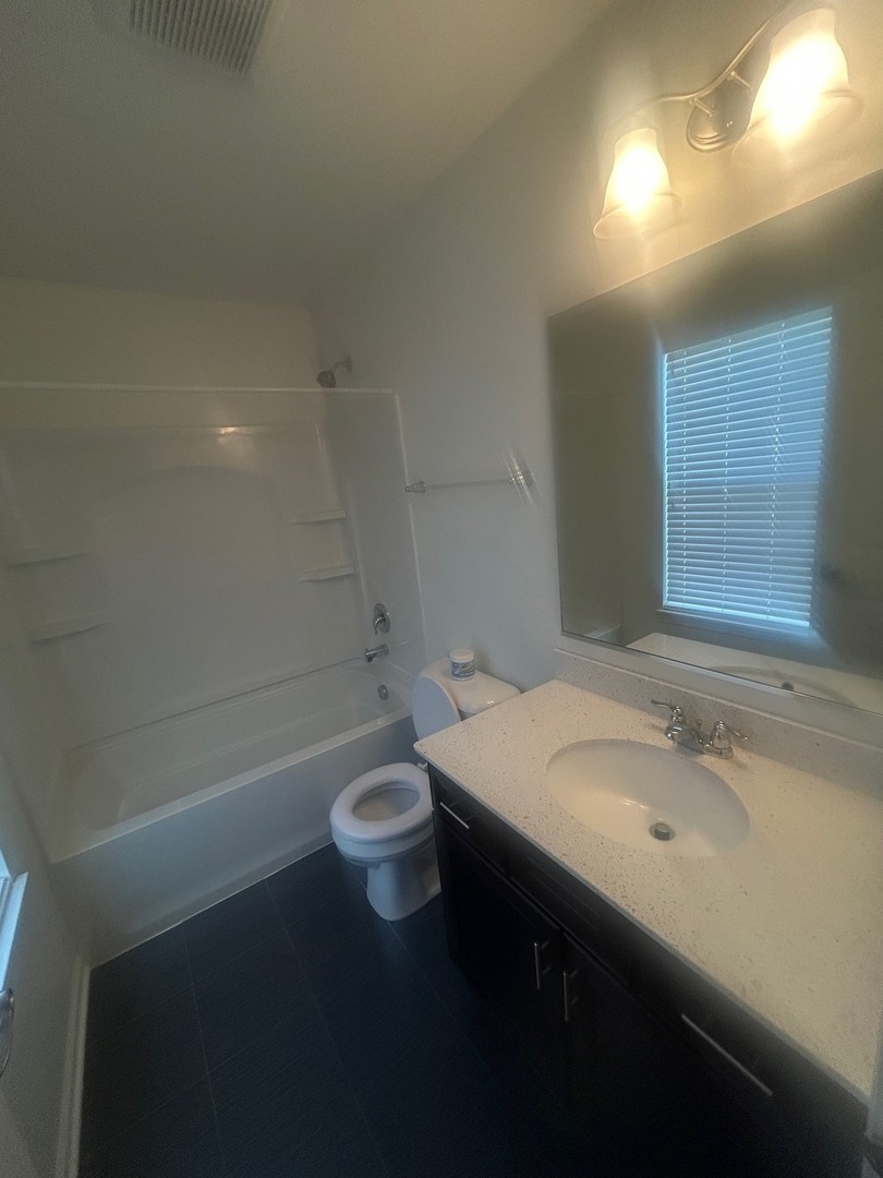2995 Henley Lane, Unit 2995 Naperville, IL 60540 - Photo 11 of 24 a bathroom with a sink a toilet and shower
