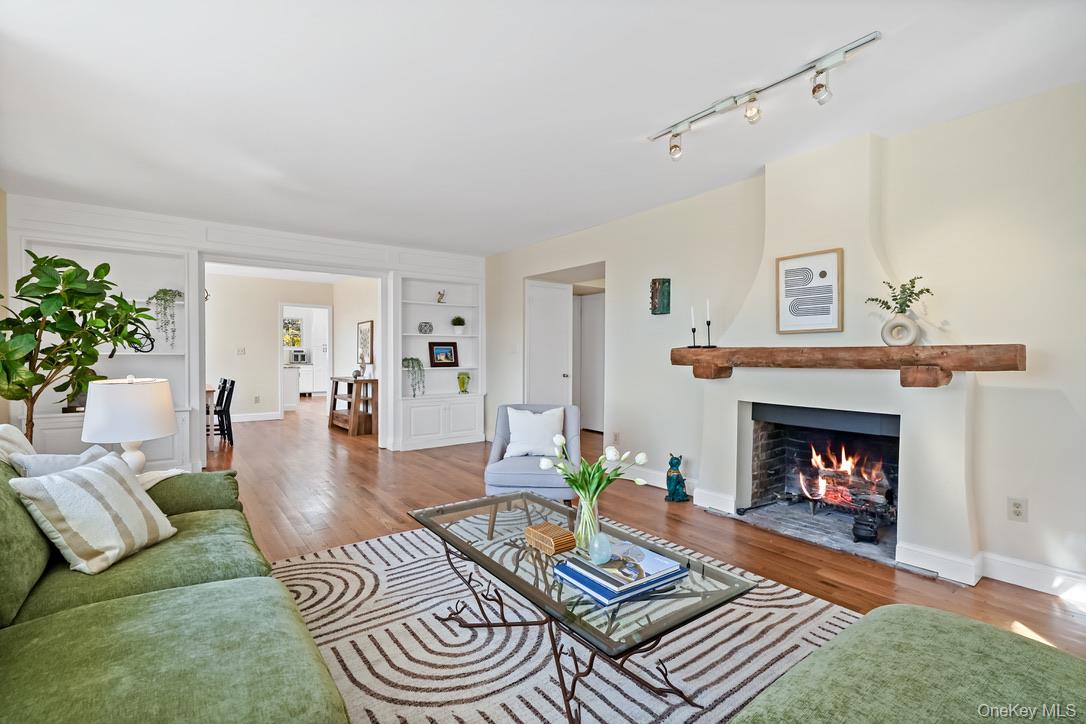 55 Greenmeadow Road Pleasantville, NY 10570 - Photo 4 of 23 Living Room with fireplace and reclaimed wood mantel, custom built-ins and bay window