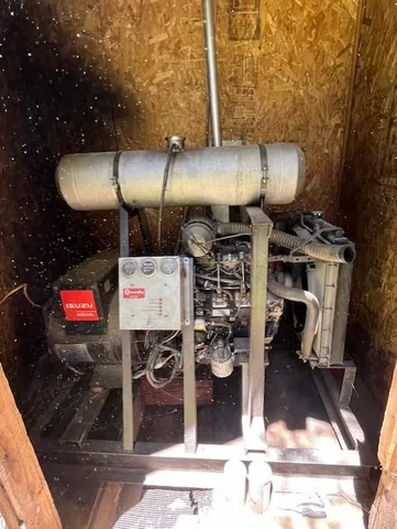 a view of house with yard outdoor seating and covered with trees