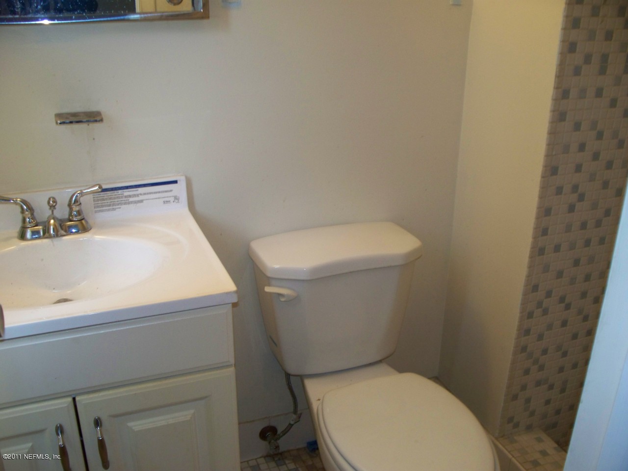 5752 Rover Drive Jacksonville, FL 32244 - Photo 12 of 16 a white toilet sitting next to a bathroom sink