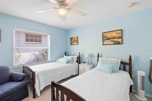 a bedroom with two beds and a couch