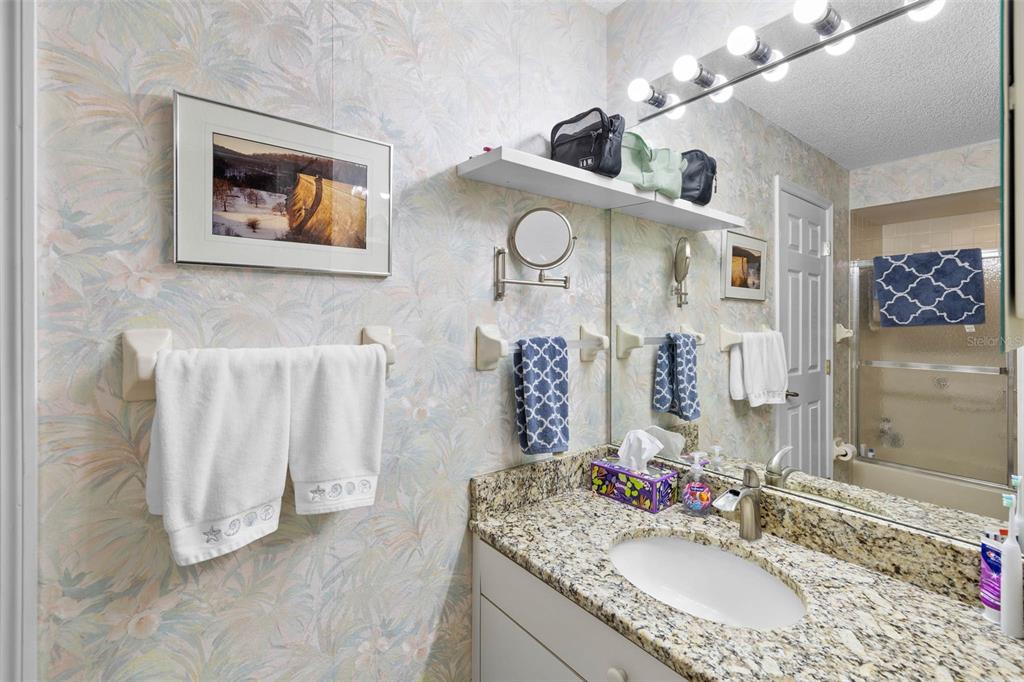 14462 Tamarind Loop Spring Hill, FL 34609 - Photo 14 of 28 a bathroom with a granite countertop double vanity sink and a mirror