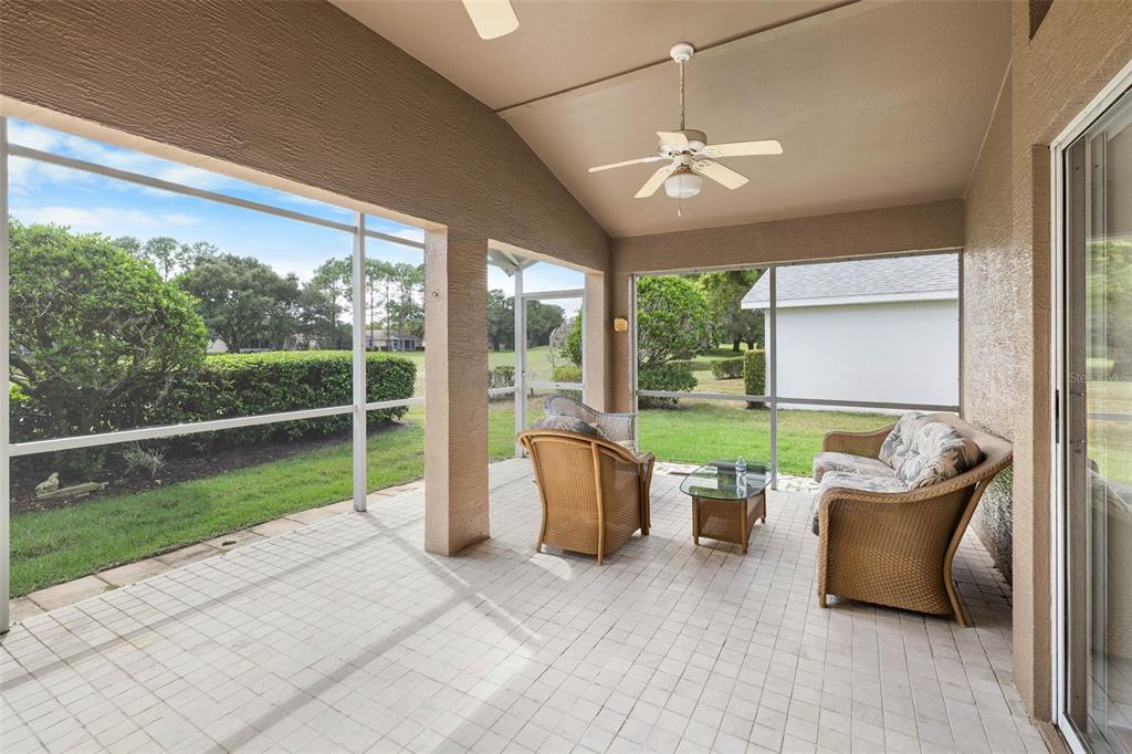 14462 Tamarind Loop Spring Hill, FL 34609 - Photo 18 of 28 a view of a porch with furniture and garden view