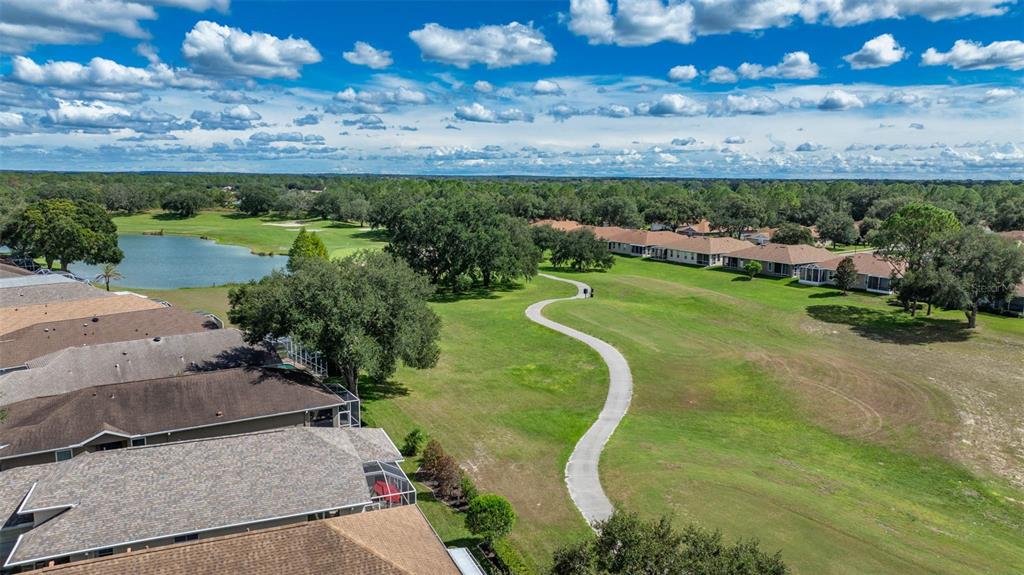 14462 Tamarind Loop Spring Hill, FL 34609 - Photo 25 of 28 an aerial view of a golf course with a yard