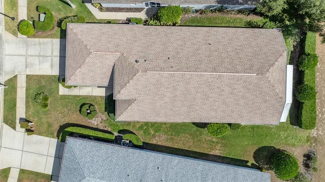 an aerial view of a house with a yard