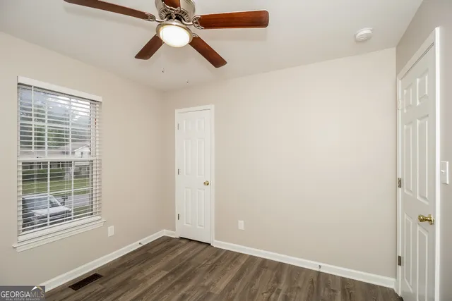wooden floor in an empty room with a window