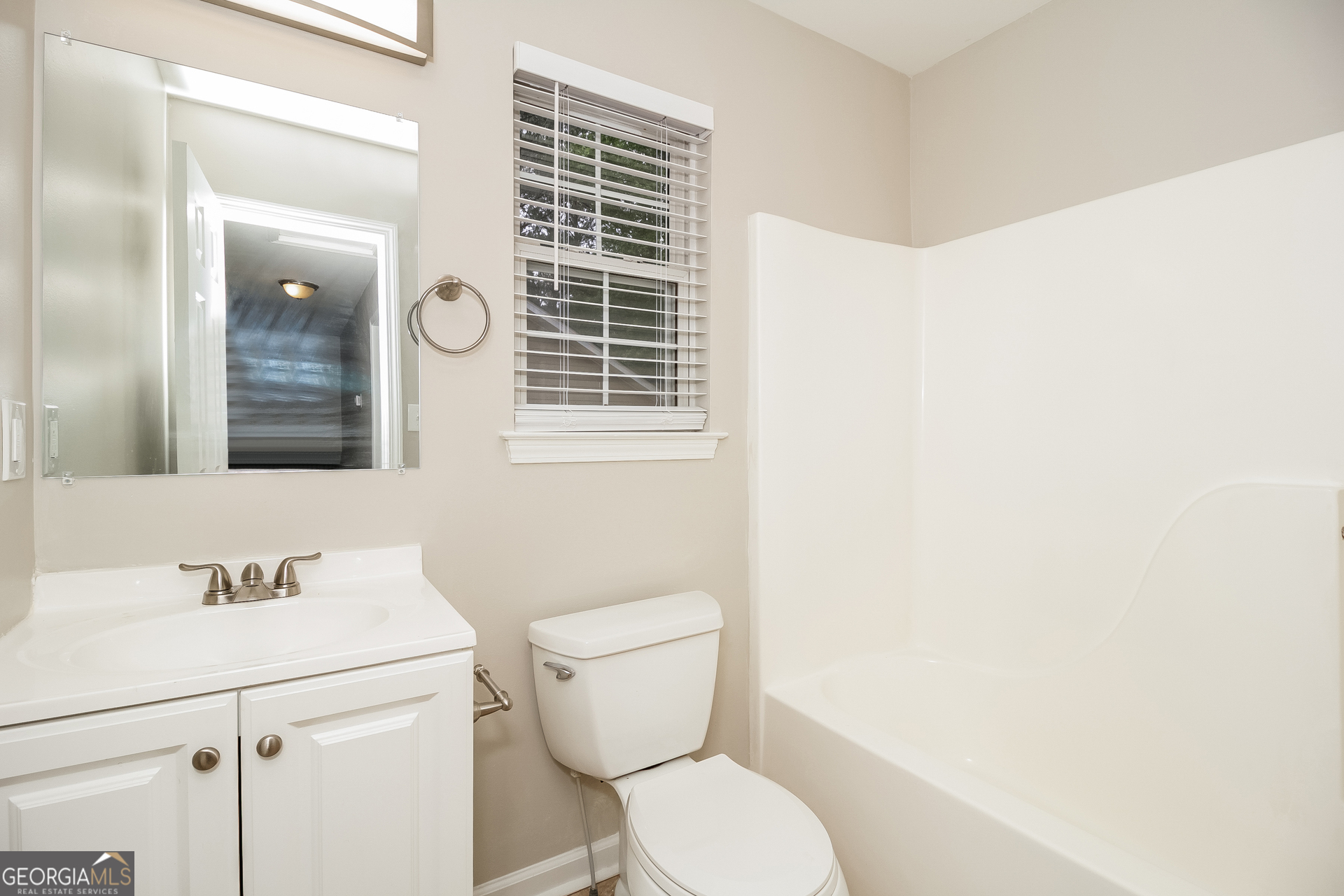 266 Amy Boulevard Temple, GA 30179 - Photo 13 of 17 a bathroom with a toilet a sink and mirror