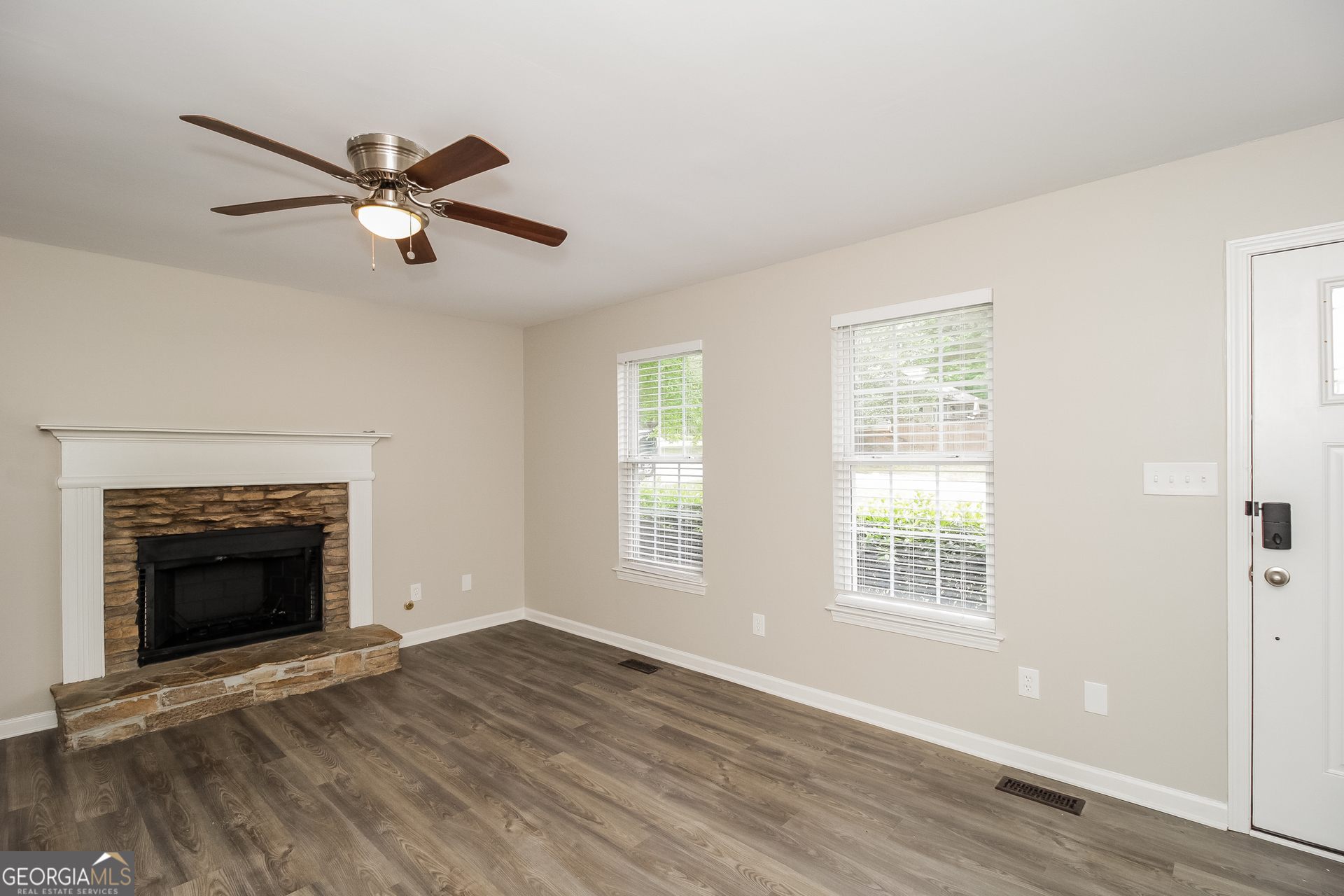 266 Amy Boulevard Temple, GA 30179 - Photo 3 of 17 a view of an empty room with wooden floor fireplace and a window
