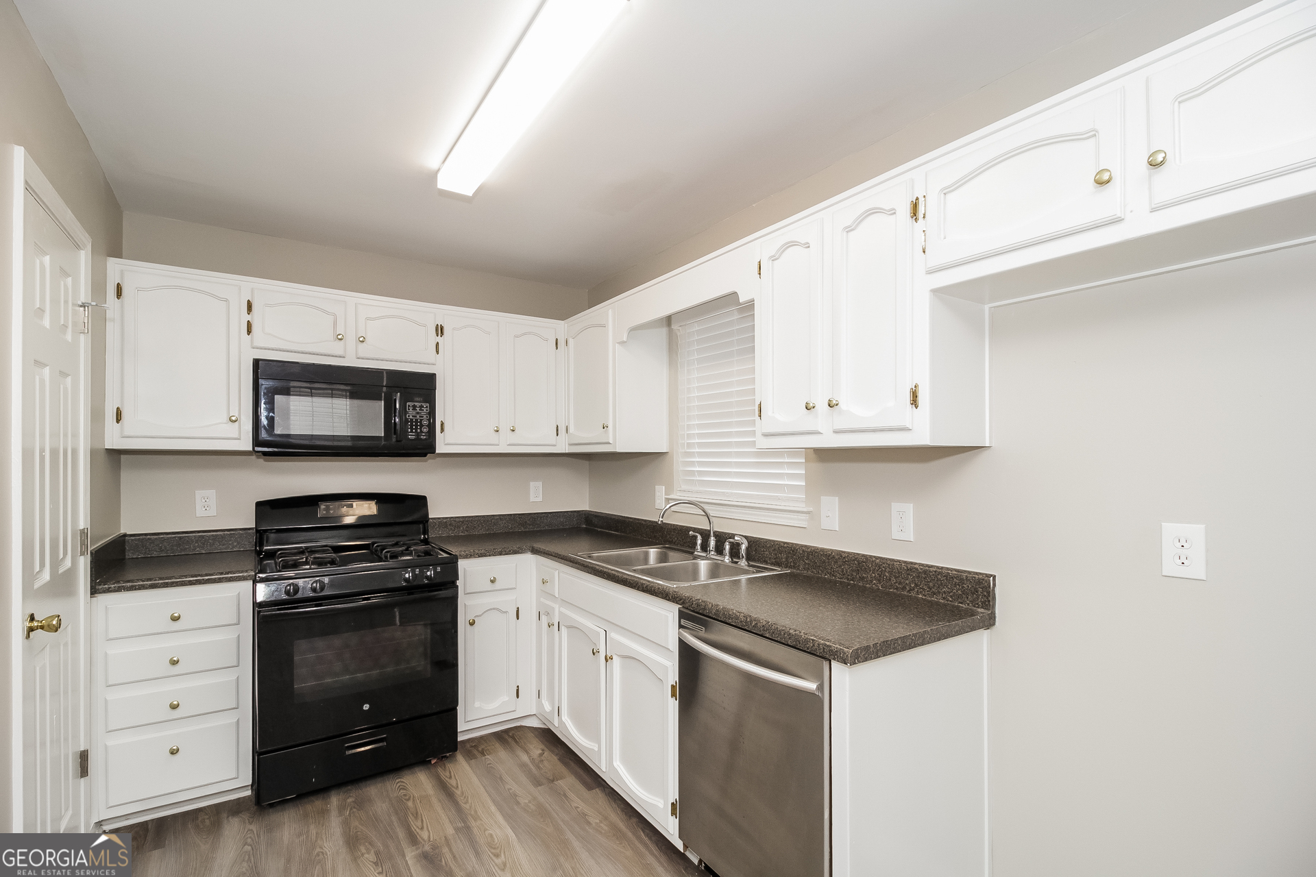 266 Amy Boulevard Temple, GA 30179 - Photo 7 of 17 a kitchen with white cabinets and appliances