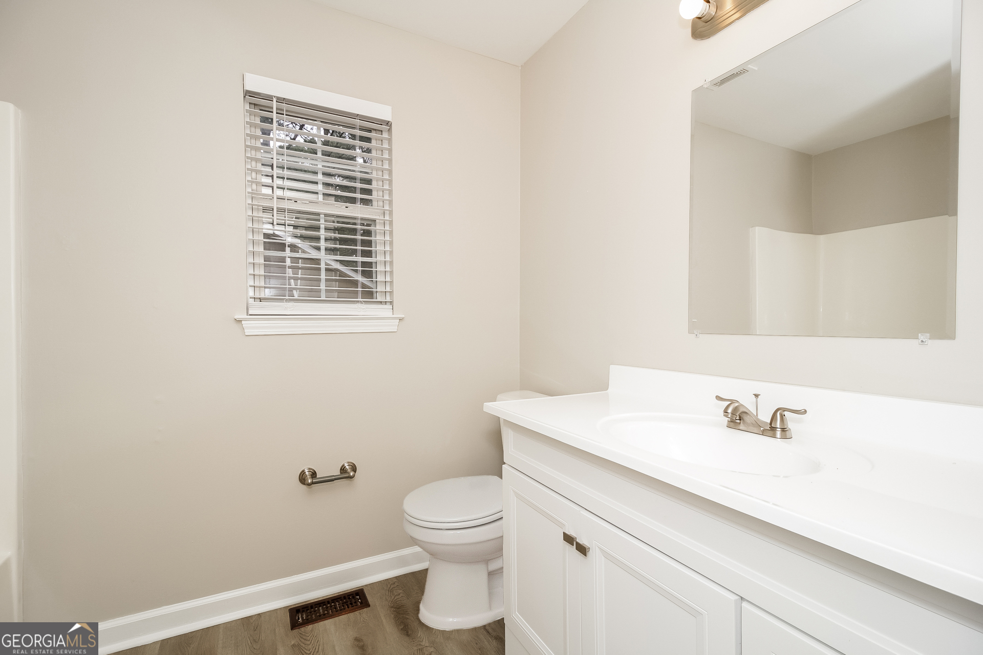 266 Amy Boulevard Temple, GA 30179 - Photo 10 of 17 a bathroom with a sink a toilet and a mirror