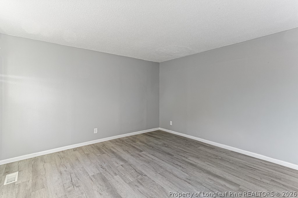 922 Rancho Drive Fayetteville, NC 28303 - Photo 7 of 21 a view of an empty room with wooden floor