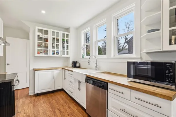a kitchen with a sink stove and cabinets