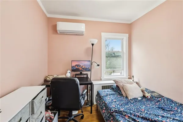 a bedroom with a bed and a window