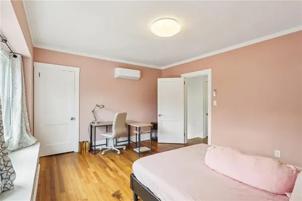 a bedroom with a bed a table and a window