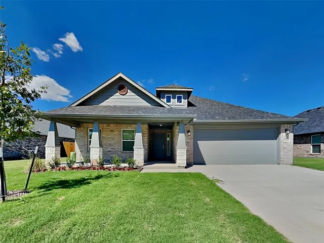 a front view of a house with a yard and porch