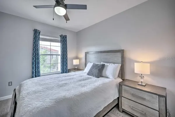 a bedroom with a bed and a chandelier