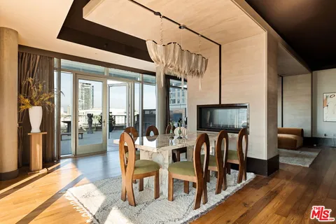 a dining room with furniture and wooden floor