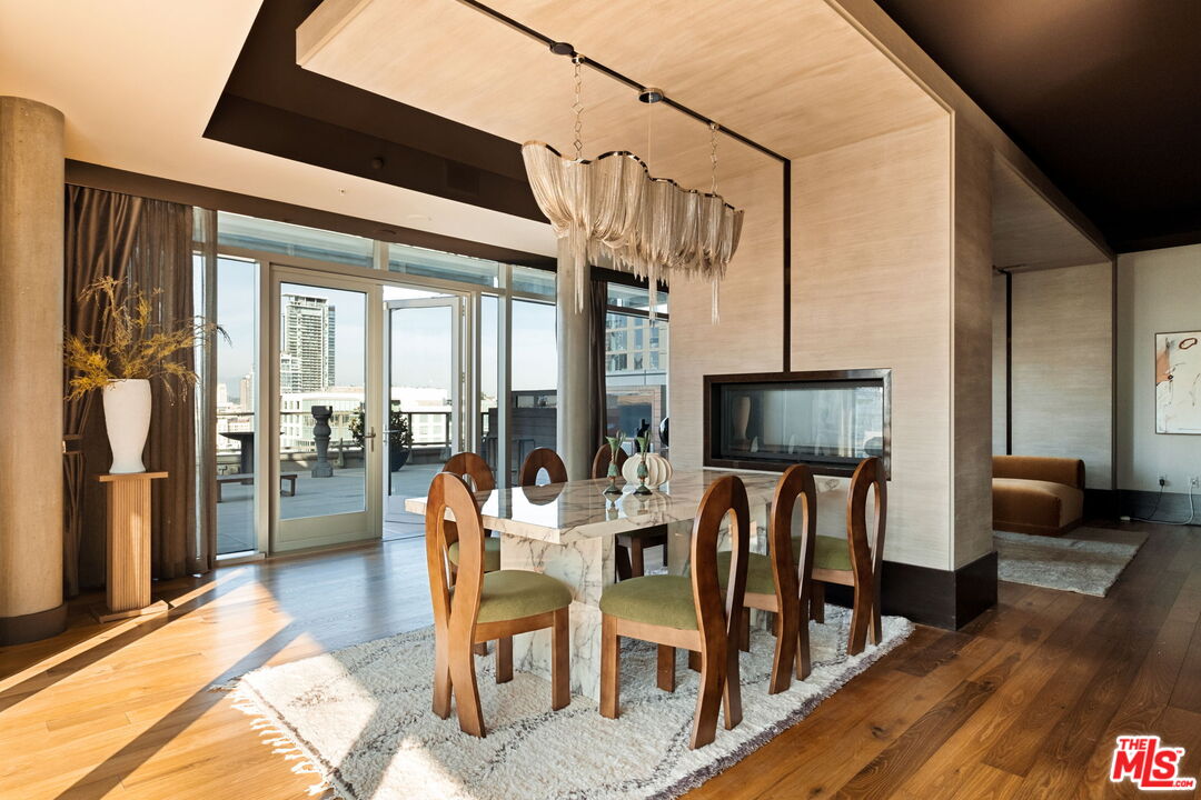 1155 South Grand Avenue, Unit 2204 Los Angeles, CA 90015 - Photo 11 of 50 a dining room with furniture and wooden floor