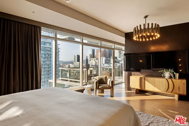 a bedroom with a large bed and a large window