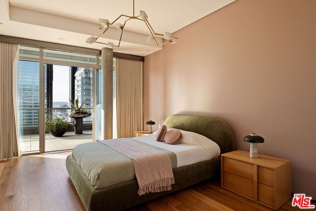 a bedroom with a bed and a chandelier