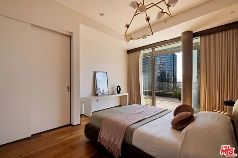 a bedroom with a bed and a large window