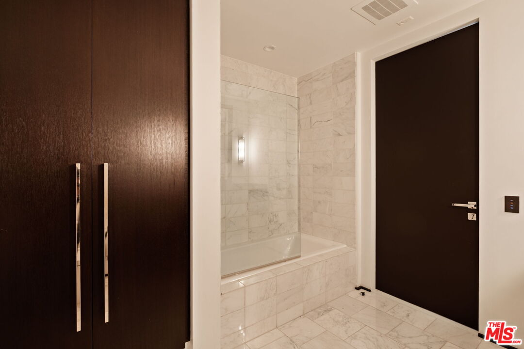 1155 South Grand Avenue, Unit 2204 Los Angeles, CA 90015 - Photo 34 of 50 a bathroom with a shower and a glass door