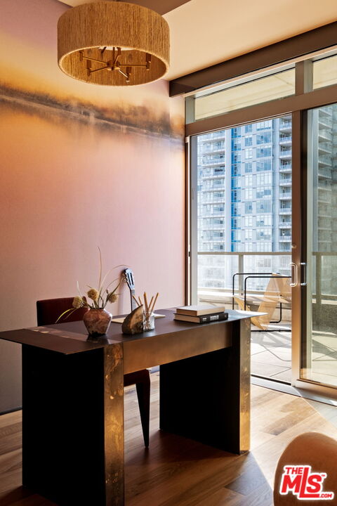 1155 South Grand Avenue, Unit 2204 Los Angeles, CA 90015 - Photo 36 of 50 a room with a table chairs and wooden floor