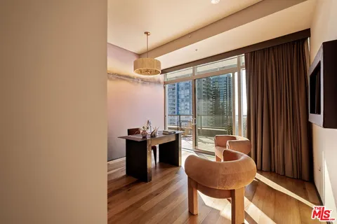 a reading room with wooden floor and furniture