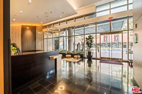 a hallway with a large window and dining table