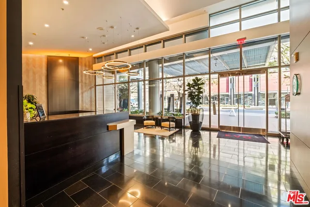 a hallway with a large window and dining table