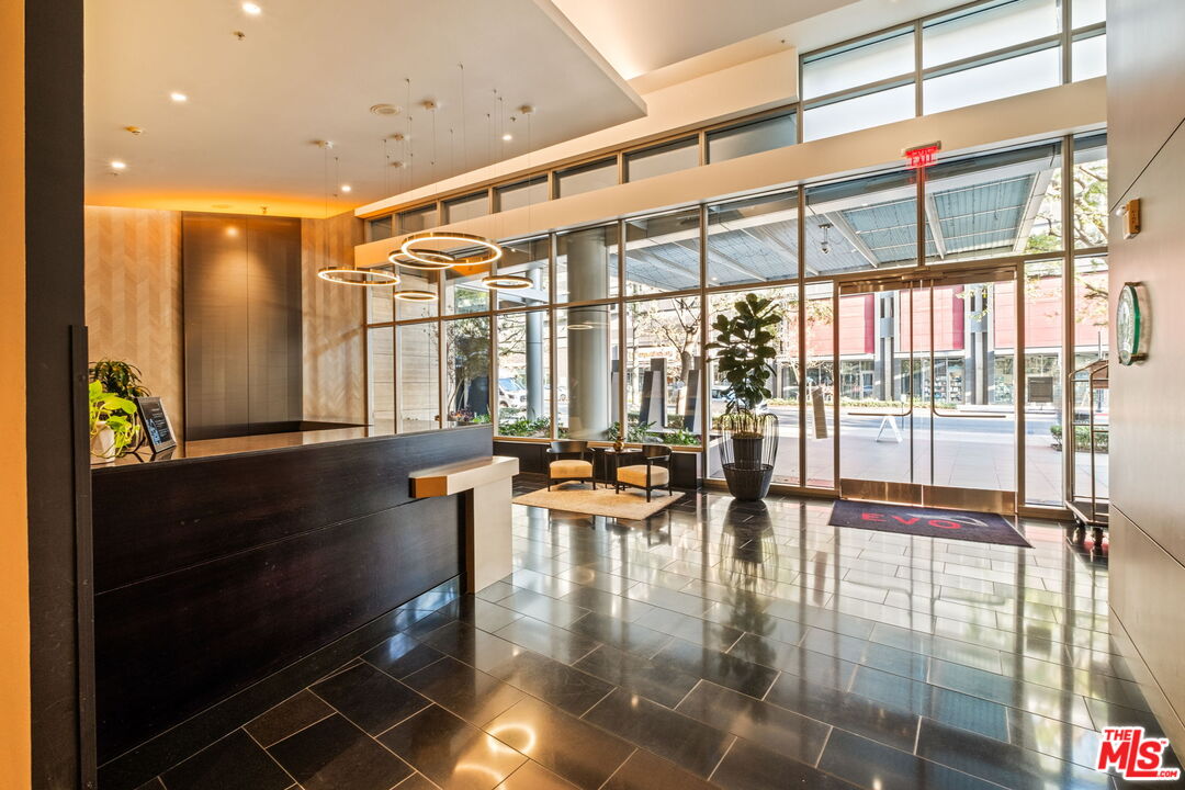 1155 South Grand Avenue, Unit 2204 Los Angeles, CA 90015 - Photo 43 of 50 a hallway with a large window and dining table