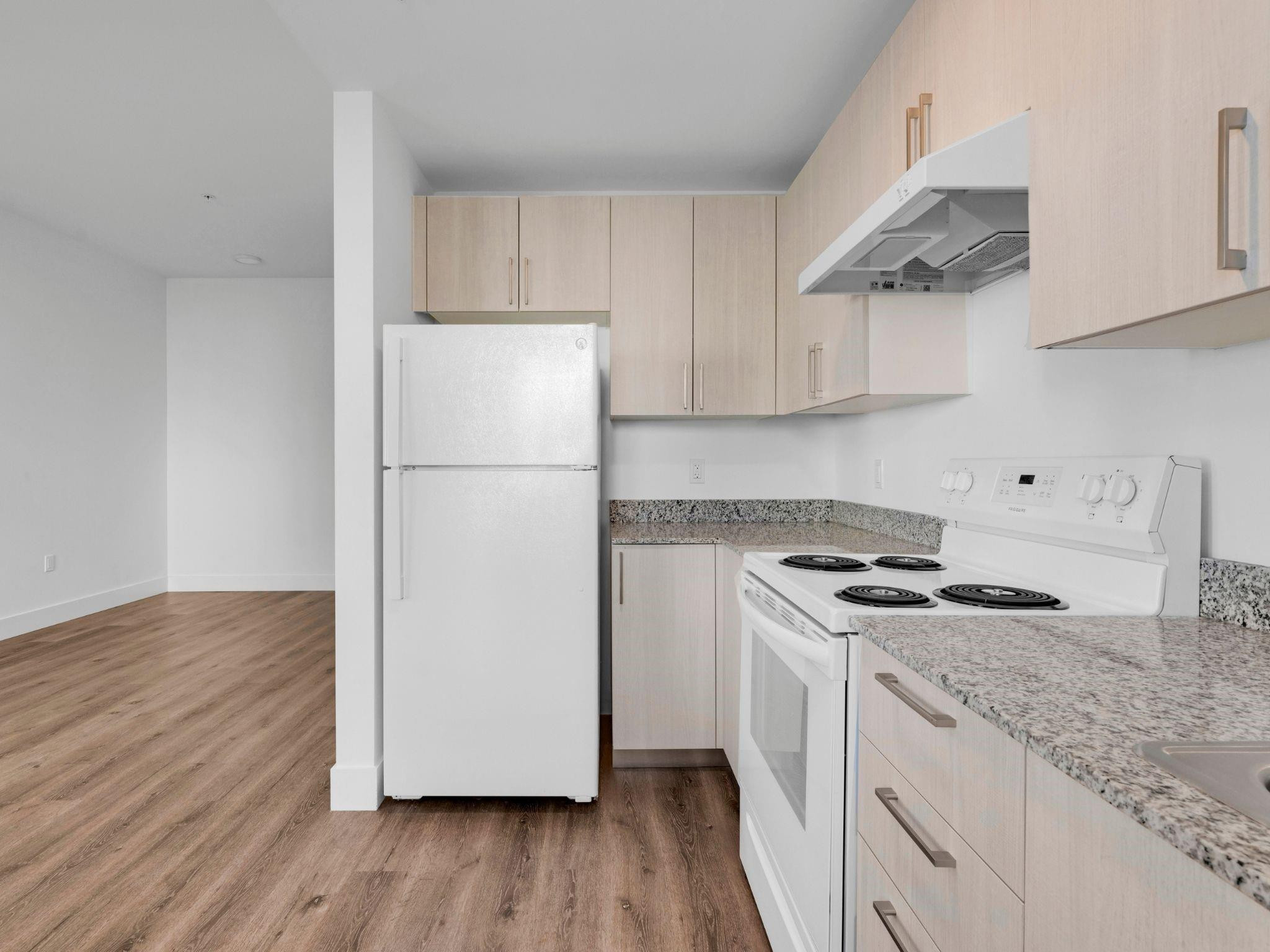 2130 Northwest 37th Street, Unit STUDIO Miami, FL 33142 - Photo 5 of 17 a white refrigerator freezer sitting inside of a kitchen