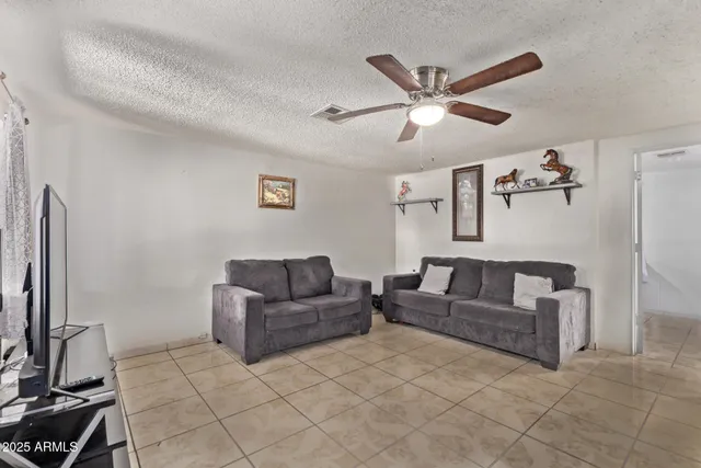 a living room with couches and a flat screen tv