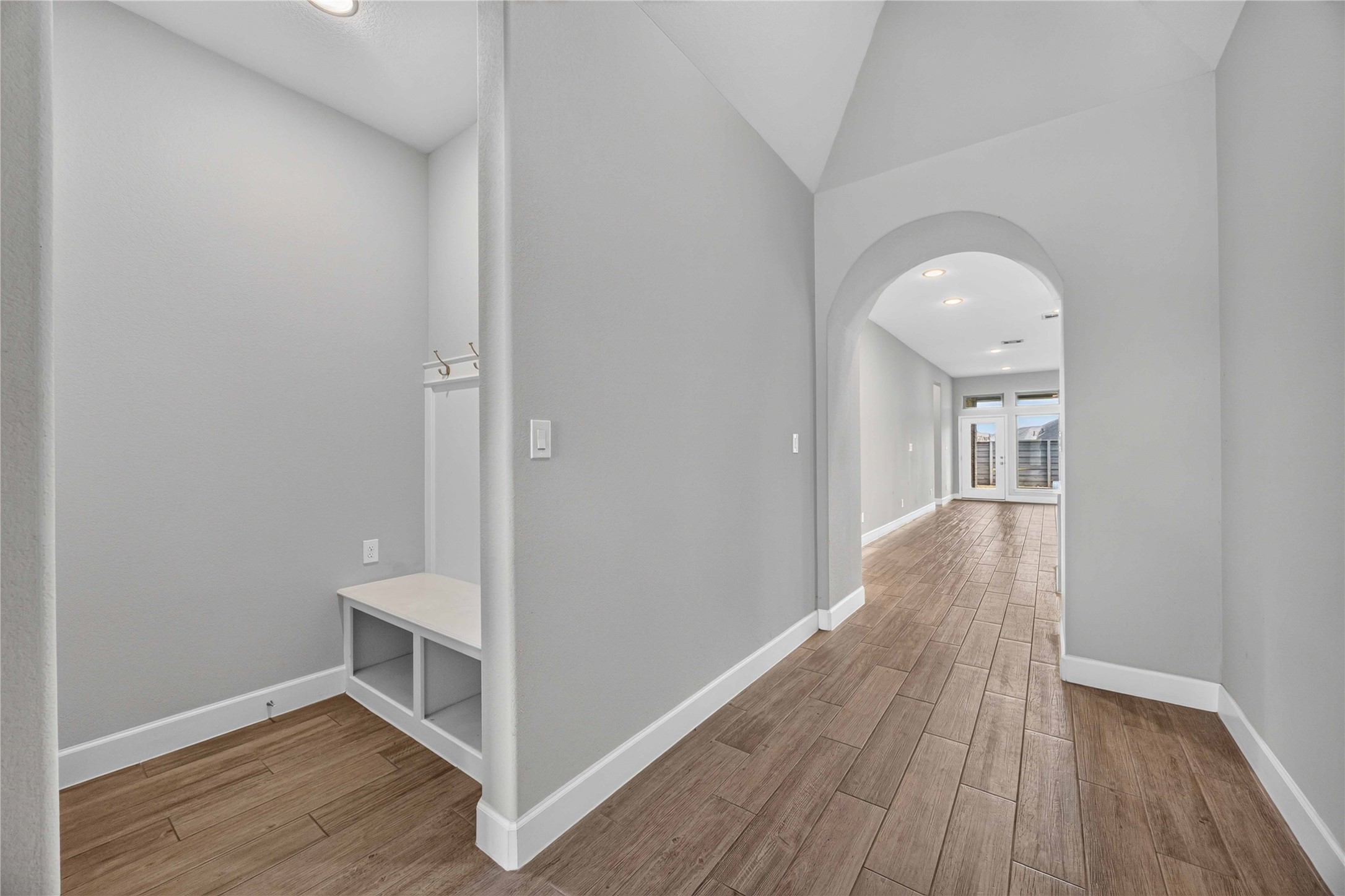 4333 Arbor Crest Lane Manvel, TX 77578 - Photo 6 of 40 A conveniently placed drop zone near the entrance provides seamless daily organization, offering a charming glimpse into the main living areas through a graceful archway.