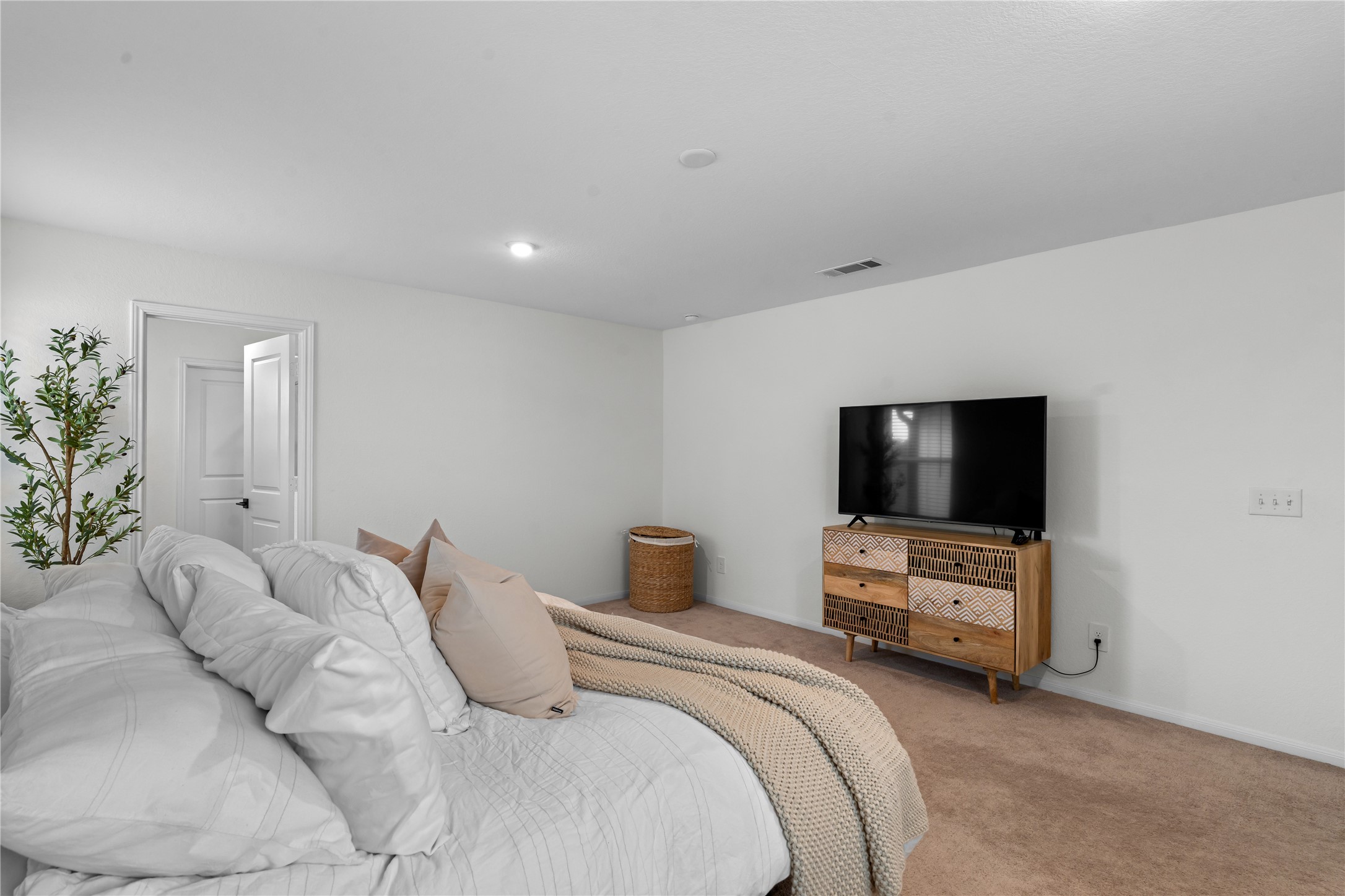 23439 Wrexham Street Spring, TX 77373 - Photo 18 of 26 a bedroom with a bed and a flat screen tv