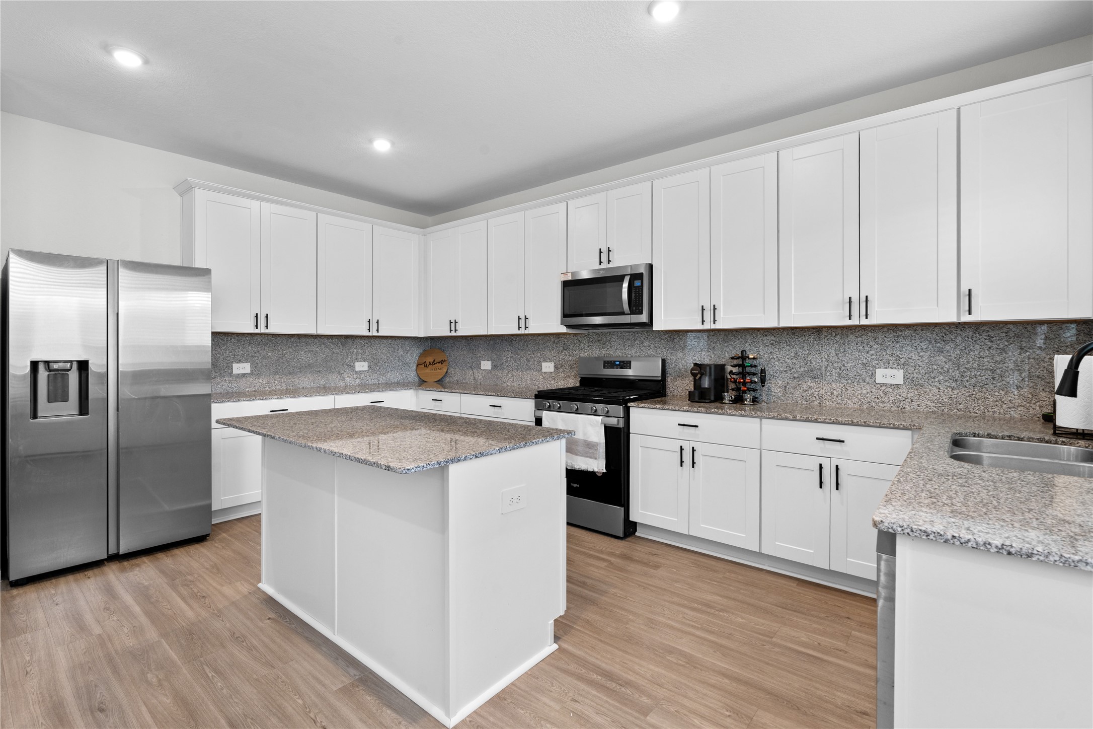 23439 Wrexham Street Spring, TX 77373 - Photo 3 of 26 a kitchen with stainless steel appliances granite countertop a stove a sink and a refrigerator