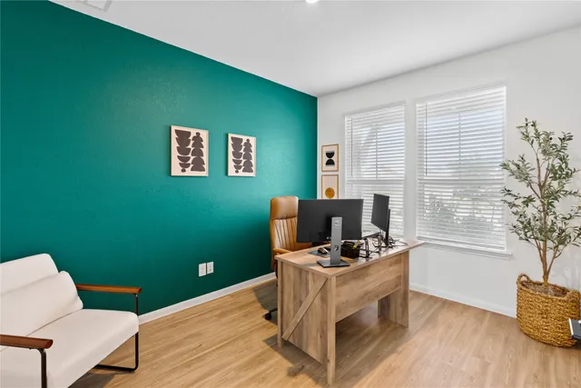 a workspace with furniture and a wooden floor