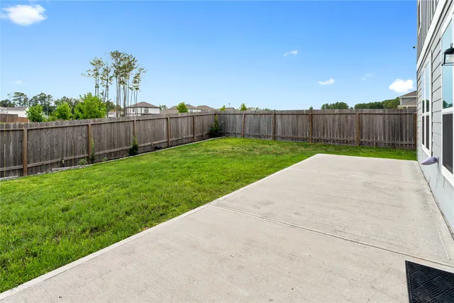 a view of a backyard with wooden fence